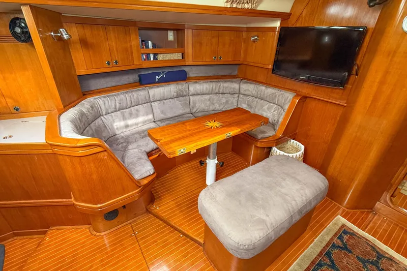 Slide: The Image of Cozy interior of a 1990 Baltic 52 yacht with plush seating and wooden accents. - 16