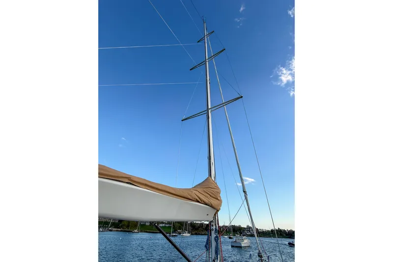 Slide: The Image of Sailboat mast of 1990 Baltic 52 against clear blue sky. - 57