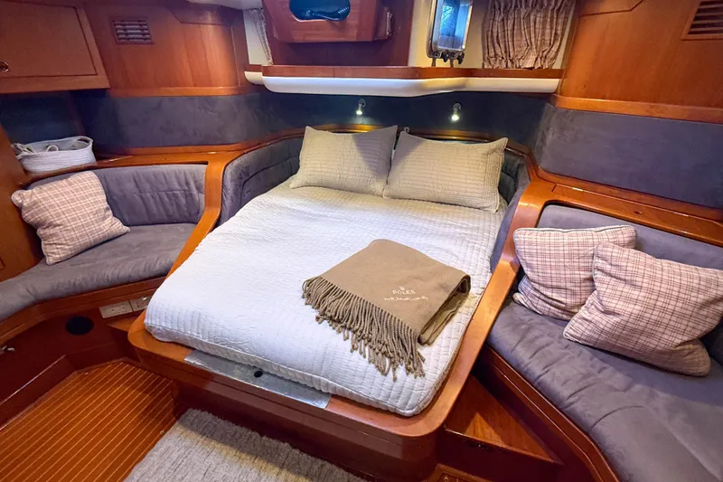 Slide: The Image of Cozy cabin interior of a 1990 Baltic 52 yacht with plush bedding and wooden accents. - 35