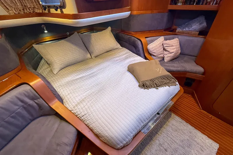 Slide: The Image of Cozy cabin interior of a 1990 Baltic 52 yacht with a comfortable bed and seating area. - 36
