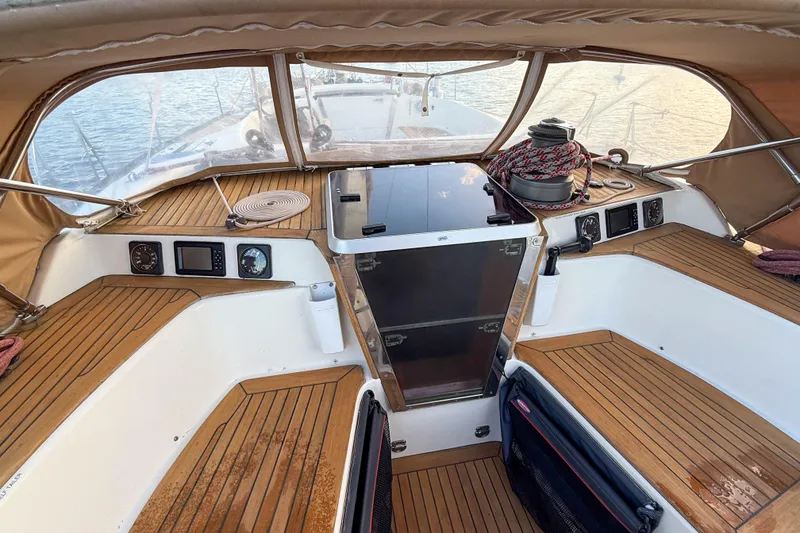 Slide: The Image of Cockpit of a 1990 Baltic 52 sailboat with teak flooring and navigation instruments. - 53