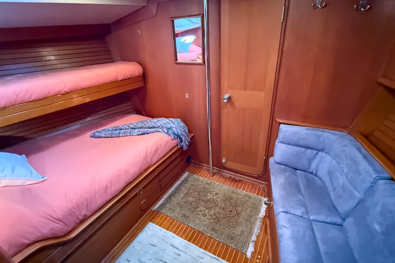 Slide: The Image of Cozy cabin interior of a 1990 Baltic 52 yacht with bunk beds and seating area. - 20