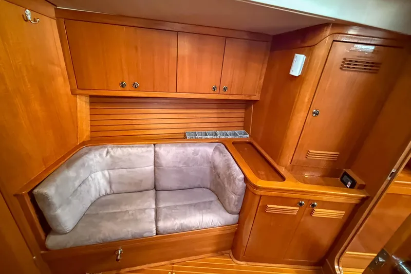 Slide: The Image of Luxurious wooden interior of a 1990 Baltic 52 yacht with cozy seating area. - 21