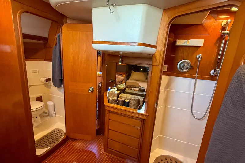 Slide: The Image of Luxurious Baltic 52 yacht bathroom interior, featuring wooden cabinetry, shower, and toilet, built in 1990. - 38