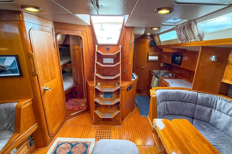 Slide: The Image of Luxurious interior of a 1990 Baltic 52 yacht with wooden finishes and cozy seating. - 45