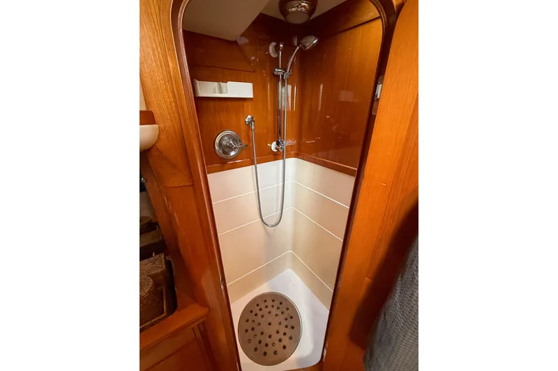 Slide: The Image of Shower area in a 1990 Baltic 52 yacht, featuring wood paneling and modern fixtures. - 41