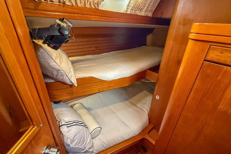 Slide: The Image of Cozy wooden bunk beds in a 1990 Baltic 52 yacht cabin. - 34