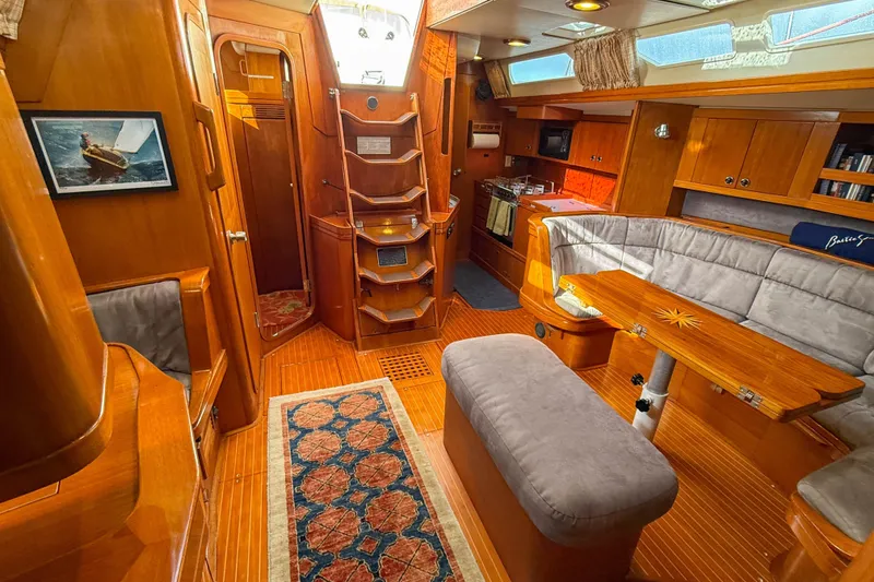 Slide: The Image of Luxurious interior of a 1990 Baltic 52 yacht with wooden finishes and cozy seating. - 15