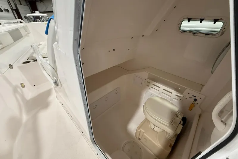 Slide: The Image of 2012 Everglades 275 Center Console boat interior with compact marine toilet. - 10