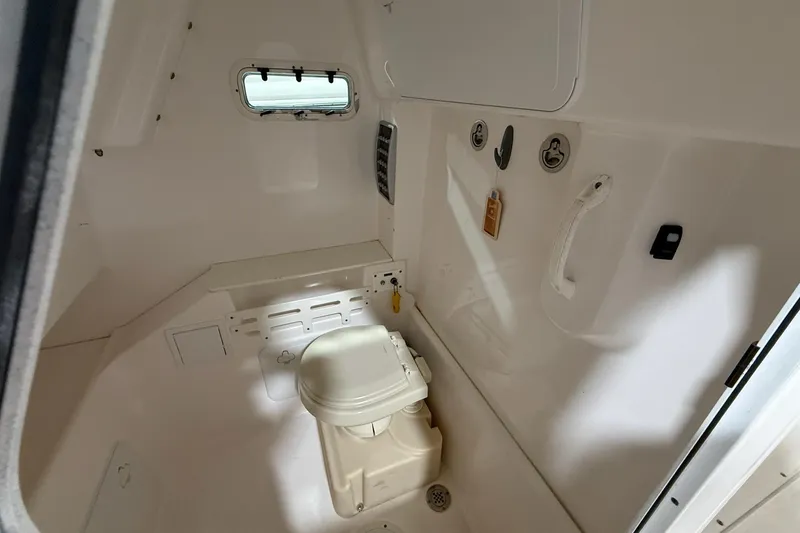 Slide: The Image of Interior of 2012 Everglades 275 Center Console boat with compact marine toilet. - 11