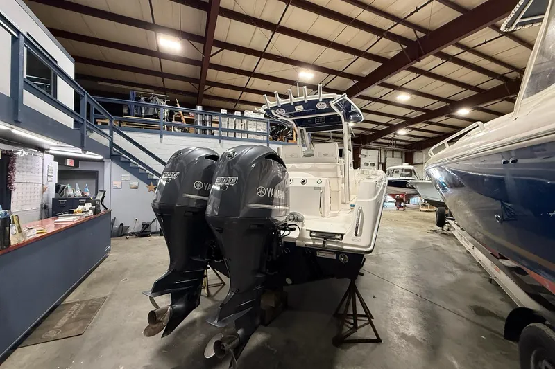 Slide: The Image of 2012 Everglades 275 Center Console boat with twin Yamaha engines in a storage facility. - 14