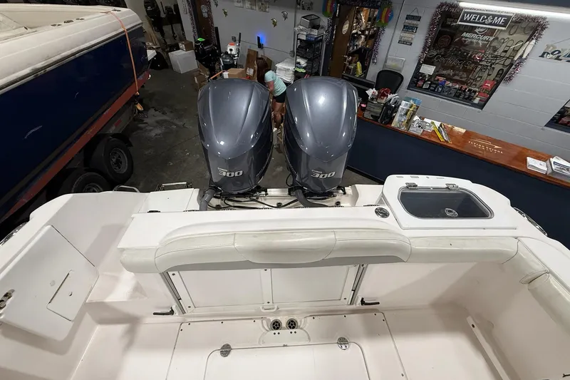 Slide: The Image of 2012 Everglades 275 Center Console boat with dual 300 horsepower engines in a showroom. - 4