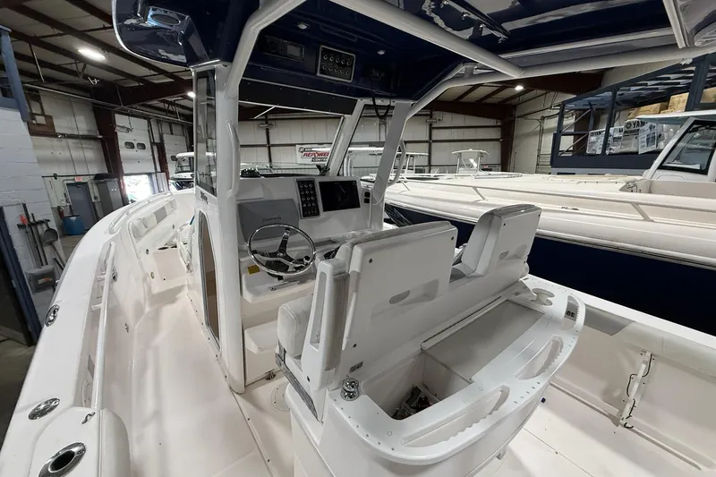 Slide: The Image of Interior view of a 2012 Everglades 275 Center Console boat in a warehouse setting. - 6