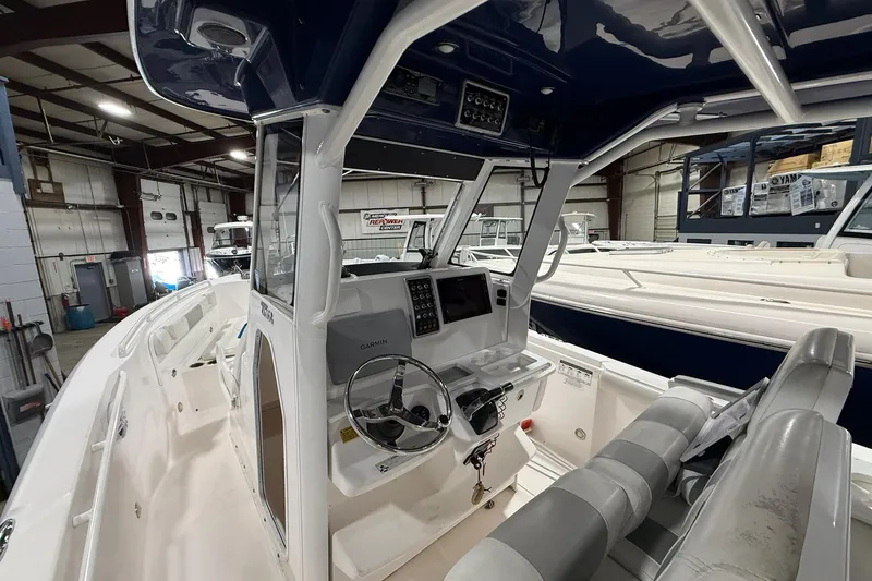 Slide: The Image of 2012 Everglades 275 Center Console boat interior with steering wheel and navigation system. - 9