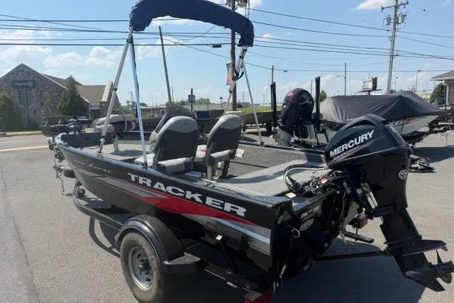 Slide: The Image of 2015 Tracker Super Guide V-16 SC boat with Mercury outboard motor on trailer. - 11