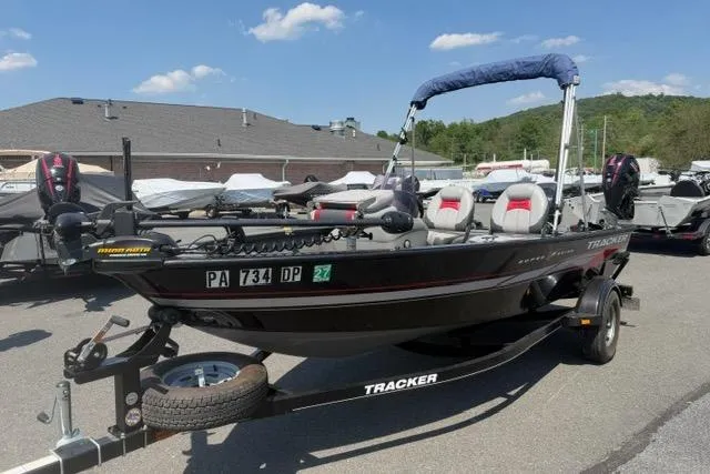 Slide: The Image of 2015 Tracker Super Guide V-16 SC fishing boat on trailer, parked outdoors. - 3