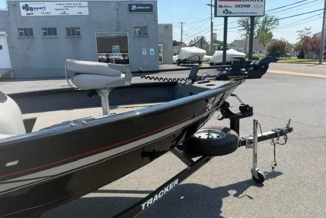 Slide: The Image of 2015 Tracker Super Guide V-16 SC boat on trailer in parking lot. - 4