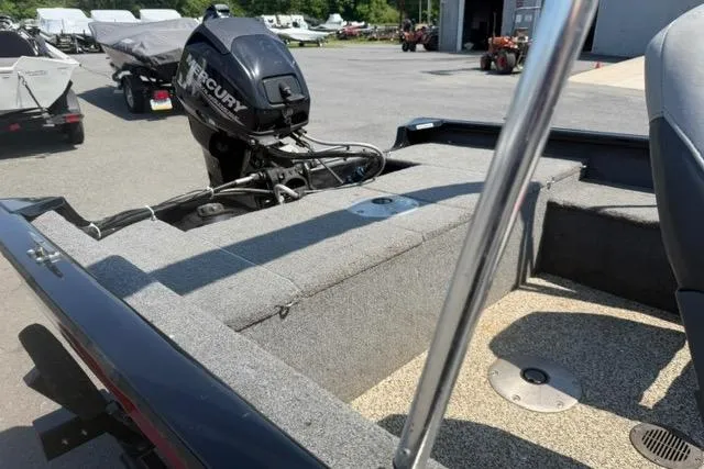 Slide: The Image of 2015 Tracker Super Guide V-16 SC boat with Mercury outboard motor in a parking lot. - 5