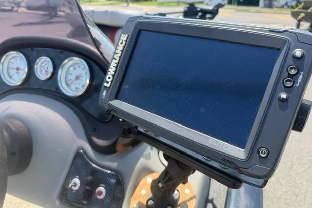 Slide: The Image of Lowrance Elite fishfinder on 2015 Tracker Super Guide V-16 SC dashboard with gauges. - 7