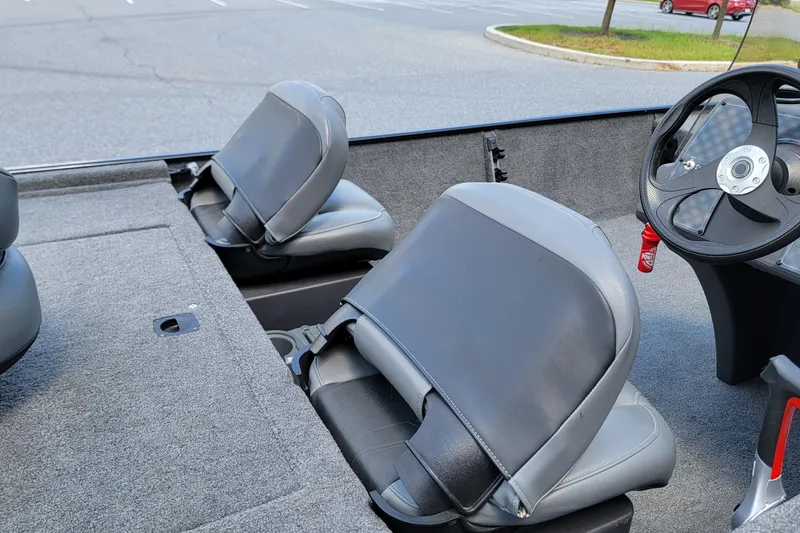 Slide: The Image of 2023 Tracker Bass Tracker Classic XL boat interior with gray seats and steering wheel. - 9