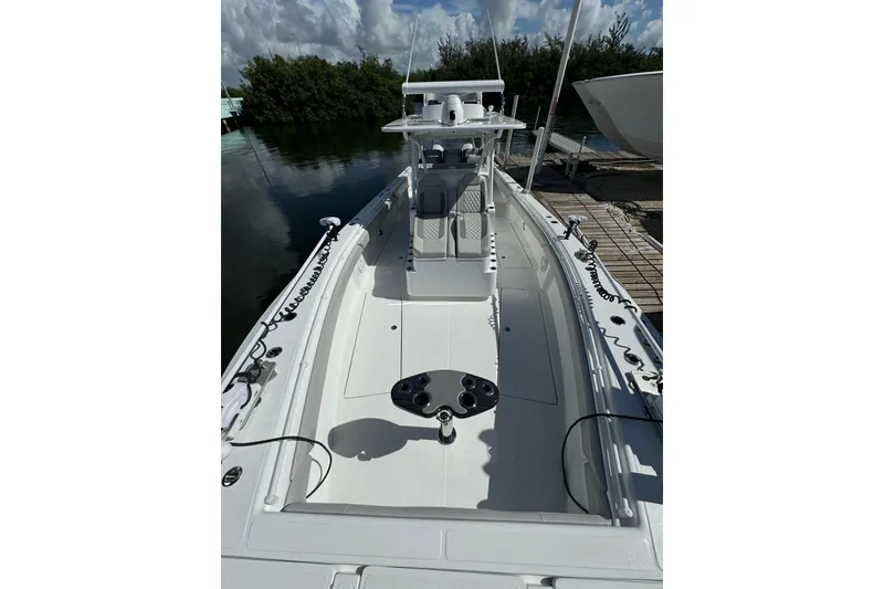 Slide: The Image of 2024 SeaHunter 41 CTS boat docked, showcasing sleek design and spacious deck. - 3