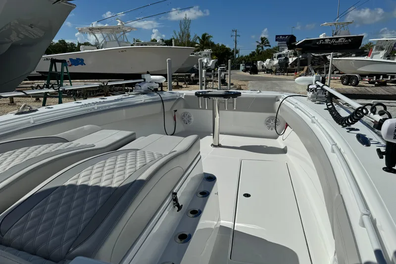 Slide: The Image of 2024 SeaHunter 41 CTS boat interior with luxurious seating and fishing rod holders. - 4