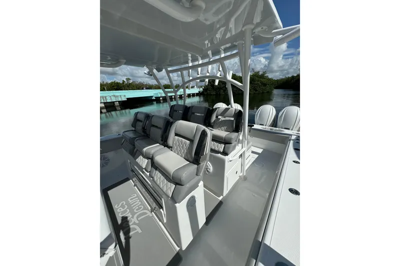 Slide: The Image of 2024 SeaHunter 41 CTS boat interior with cushioned seating and sleek design. - 5