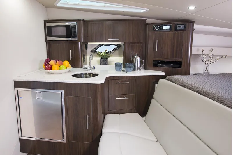 Slide: The Image of Manufacturer Provided Image: 2017 Regal 35 Sport Coupe interior kitchen with modern appliances and seating. - 7