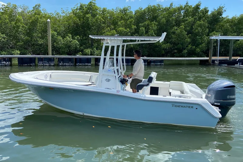 Slide: The Image of 2023 Tidewater 220 LXF boat on water, featuring sleek design and Yamaha engine. - 10