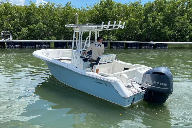 Slide: The Image of 2023 Tidewater 220 LXF boat with Yamaha engine on calm water. - 11