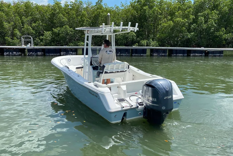 Slide: The Image of 2023 Tidewater 220 LXF boat with Yamaha 250 engine on calm water. - 12