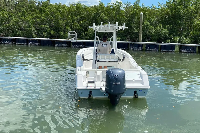 Slide: The Image of 2023 Tidewater 220 LXF boat with Yamaha 250 engine on calm water. - 13