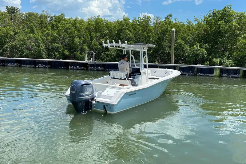 Slide: The Image of 2023 Tidewater 220 LXF boat with Yamaha engine on calm water near mangroves. - 16