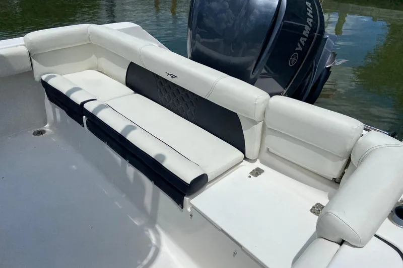 Slide: The Image of 2023 Tidewater 220 LXF boat with white seating and Yamaha engine. - 18