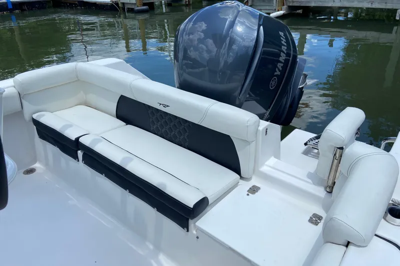 Slide: The Image of 2023 Tidewater 220 LXF boat with Yamaha engine, featuring white seating and sleek design. - 19