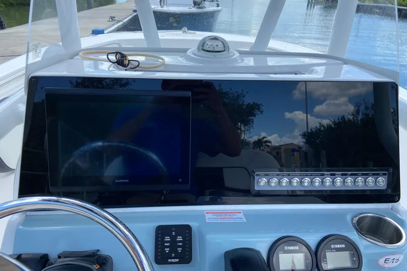 Slide: The Image of 2023 Tidewater 220 LXF boat dashboard with Garmin display and Yamaha controls. - 25