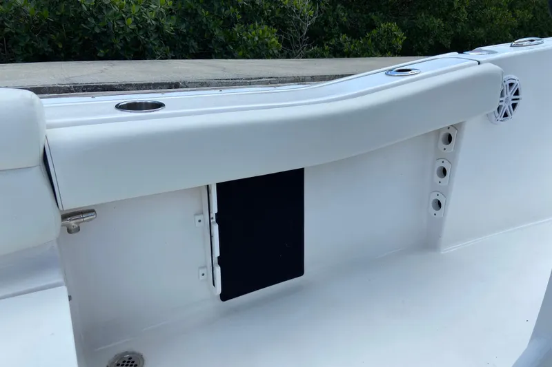 Slide: The Image of 2023 Tidewater 220 LXF boat interior detail with cup holders and speaker. - 29