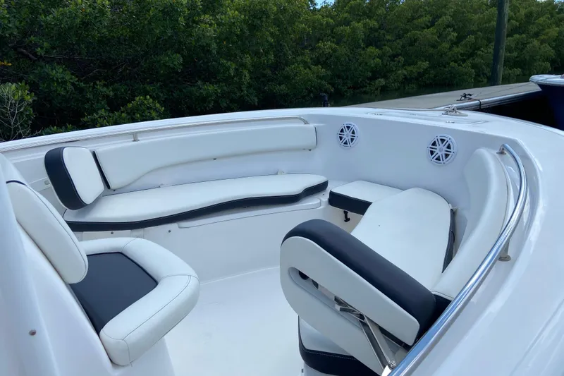 Slide: The Image of 2023 Tidewater 220 LXF boat interior with white seating and speakers. - 30