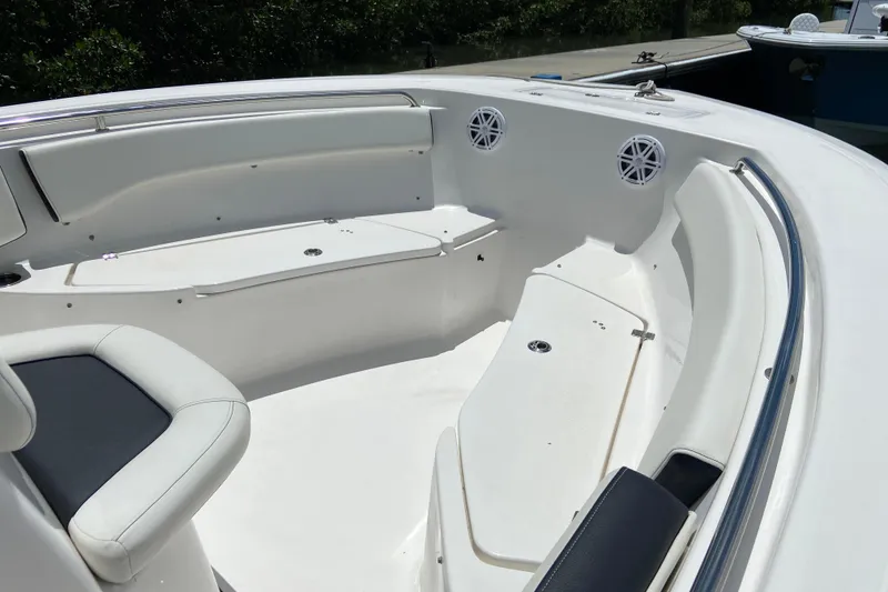 Slide: The Image of 2023 Tidewater 220 LXF boat interior with white seating and storage compartments. - 31
