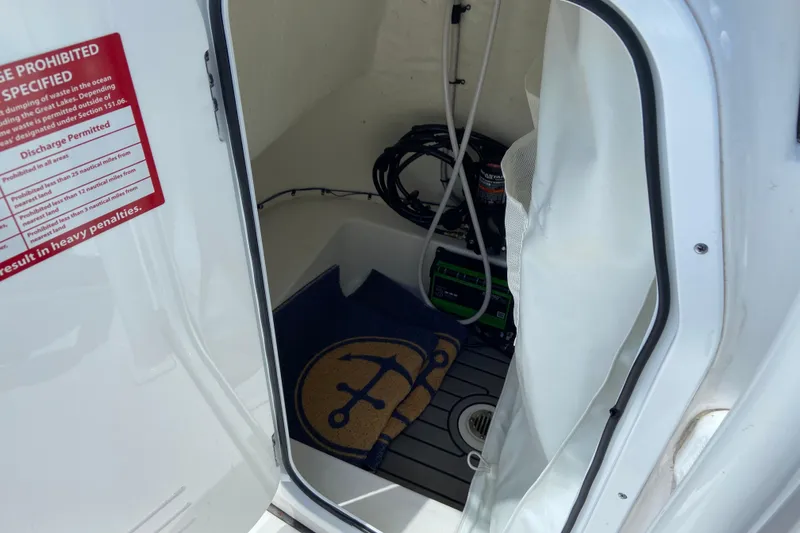 Slide: The Image of Interior view of 2023 Tidewater 220 LXF boat compartment with equipment and signage. - 34