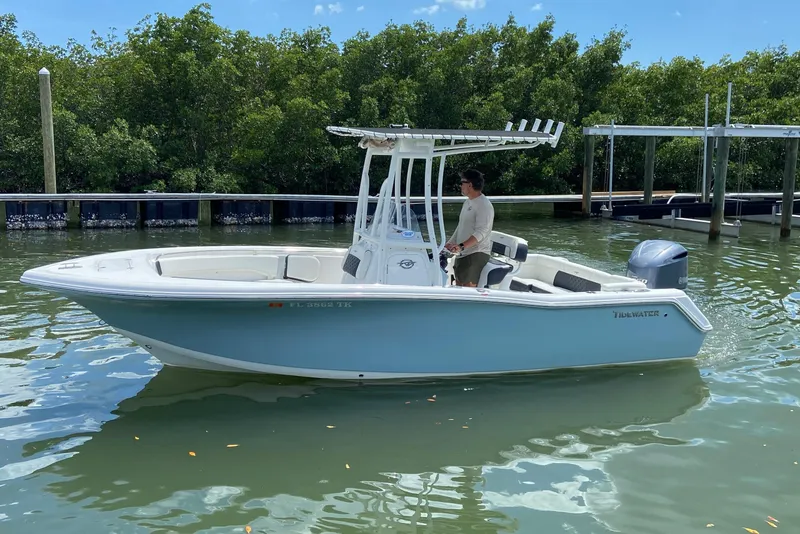 Slide: The Image of 2023 Tidewater 220 LXF boat on calm water, featuring sleek design and modern amenities. - 8