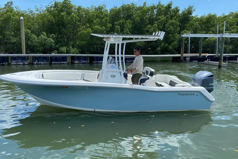 Slide: The Image of 2023 Tidewater 220 LXF boat on water, featuring sleek design and Yamaha engine. - 9