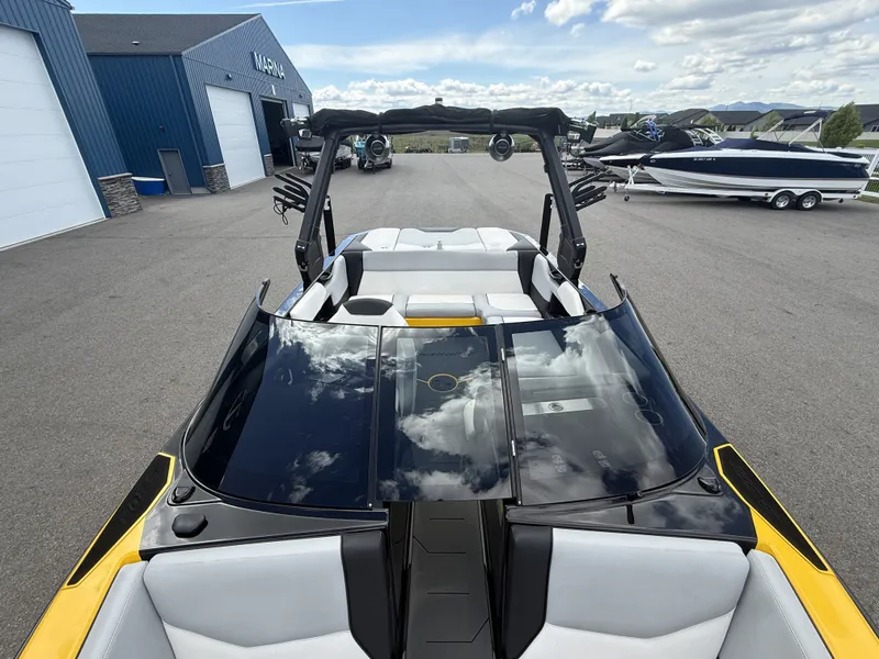Slide: The Image of 2018 Supreme S202 boat parked near a marina. - 10