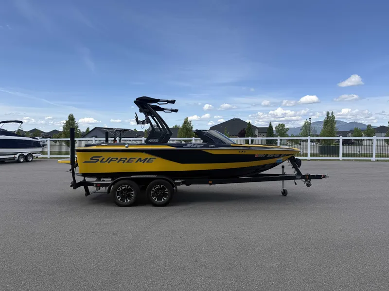 Slide: The Image of Yellow 2018 Supreme S202 boat on trailer, blue sky. - 17