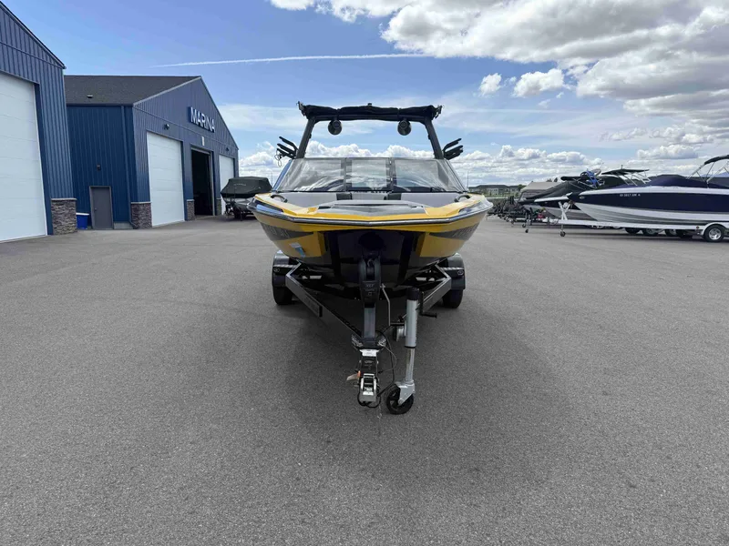 Slide: The Image of Yellow 2018 Supreme S202 boat parked outside a marina. - 3