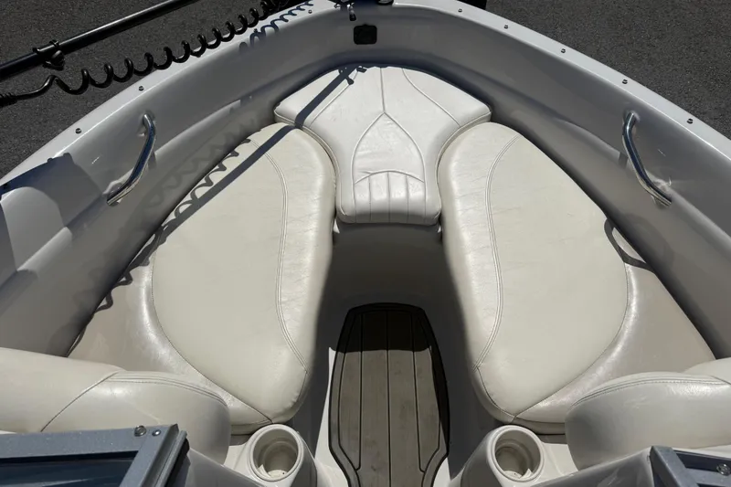 Slide: The Image of Interior of a 2008 Tahoe Q5i Sport boat with white seating and cup holders. - 12
