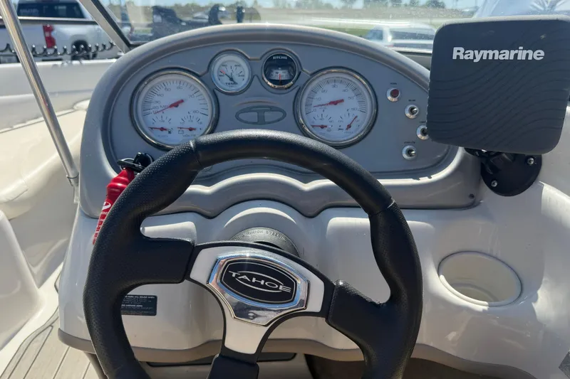 Slide: The Image of Steering wheel and dashboard of 2008 Tahoe Q5i Sport boat with Raymarine device. - 13