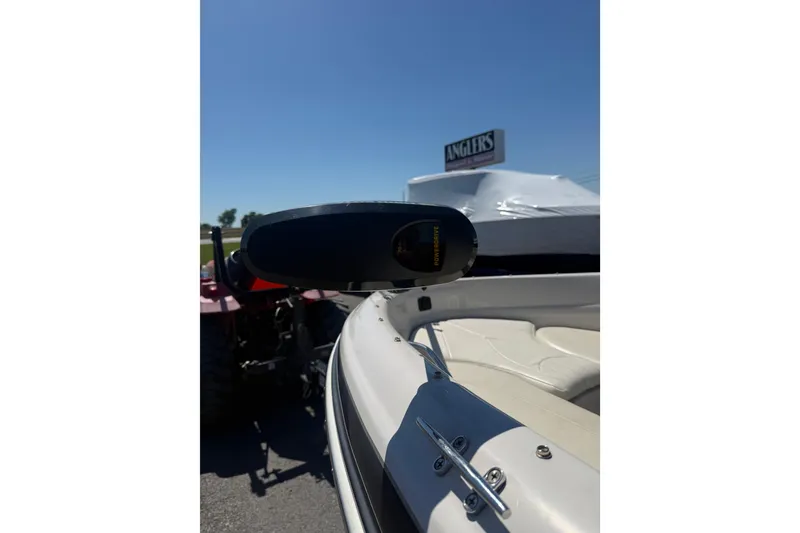 Slide: The Image of 2008 Tahoe Q5i Sport boat with PowerDrive motor, parked outdoors under clear blue sky. - 3