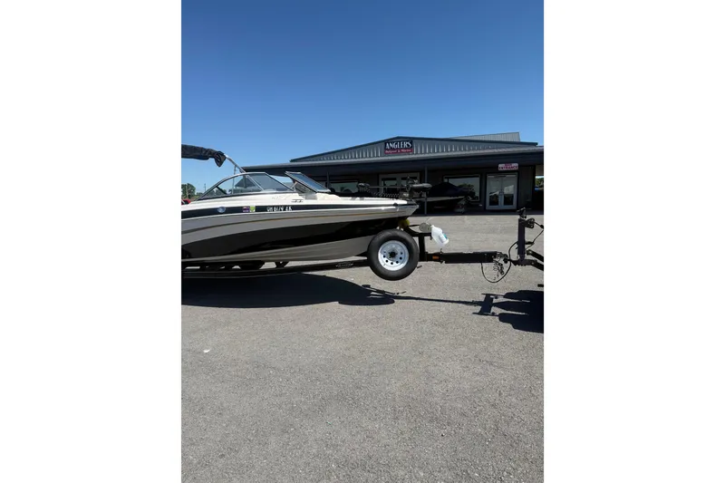 Slide: The Image of 2008 Tahoe Q5i Sport boat on trailer in front of dealership. - 6
