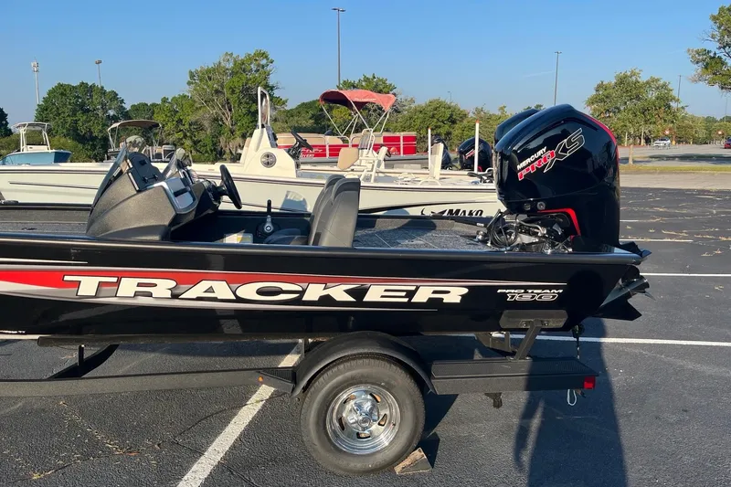 Slide: The Image of 2026 Tracker Pro Team 190 boat with Mercury engine in parking lot. - 2